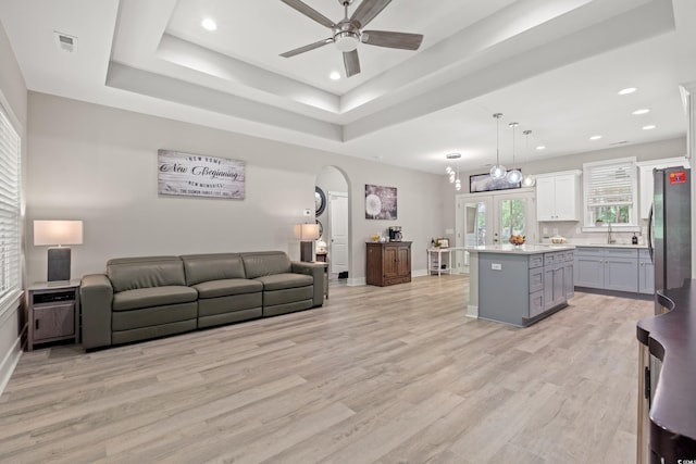 7405 Louisville Rd, Aynor, SC 29511 - living area featuring a ceiling fan, arched walkways, recessed lighting, light wood-type flooring, and a tray ceiling