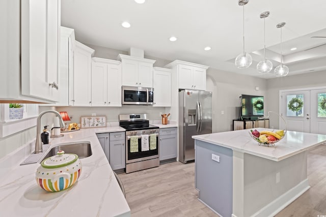 7405 Louisville Rd, Aynor, SC 29511 - kitchen featuring appliances with stainless steel finishes, recessed lighting, a center island, light wood finished floors, and light stone countertops