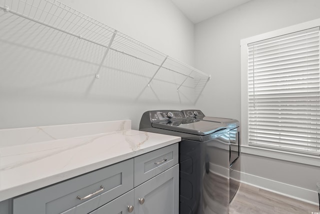 7405 Louisville Rd, Aynor, SC 29511 - washroom featuring washer and clothes dryer, light wood-style floors, and cabinet space