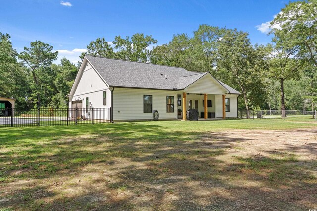 7405 Louisville Rd, Aynor, SC 29511 - back of property with a fenced backyard, roof with shingles, and view of scattered trees