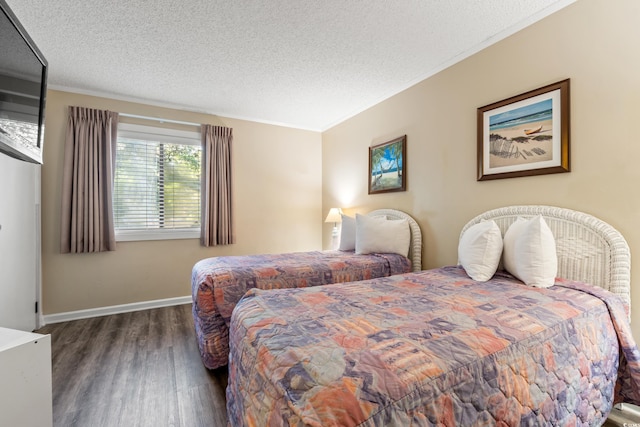 415 Ocean Creek Dr Unit 2243, Myrtle Beach, SC 29572 - bedroom featuring wood finished floors, a textured ceiling, and ornamental molding