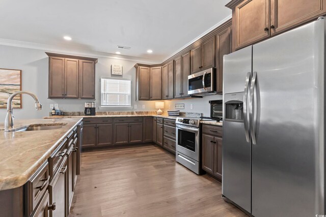 1514-B S Ocean Blvd, Surfside Beach, SC 29575 - kitchen featuring stainless steel appliances, ornamental molding, wood finished floors, light stone counters, and recessed lighting