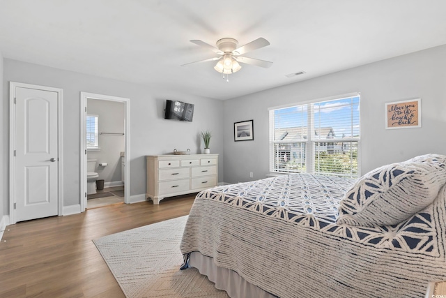1514-B S Ocean Blvd, Surfside Beach, SC 29575 - bedroom with wood finished floors, a ceiling fan, and ensuite bath