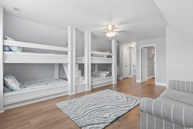 1514-B S Ocean Blvd, Surfside Beach, SC 29575 - bedroom with wood finished floors, ceiling fan, and ensuite bathroom