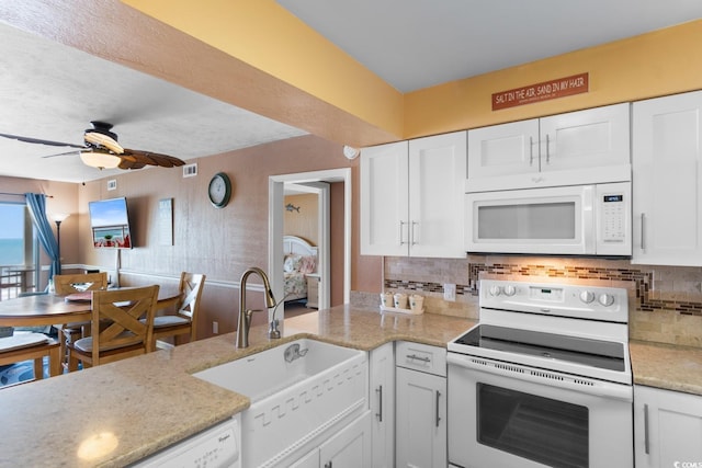 3217 S Ocean Blvd Unit 305, North Myrtle Beach, SC 29582 - kitchen featuring white appliances, ceiling fan, white cabinetry, backsplash, and light stone countertops