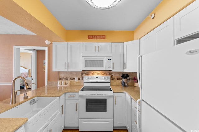 3217 S Ocean Blvd Unit 305, North Myrtle Beach, SC 29582 - kitchen with white appliances, white cabinets, tasteful backsplash, and light stone counters