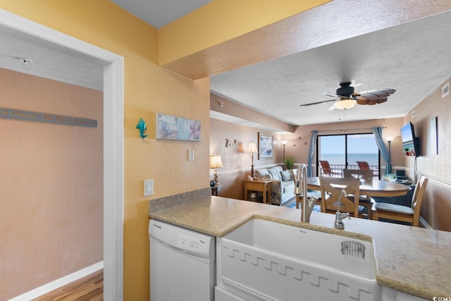 3217 S Ocean Blvd Unit 305, North Myrtle Beach, SC 29582 - kitchen featuring white dishwasher, ceiling fan, wood finished floors, and light stone counters