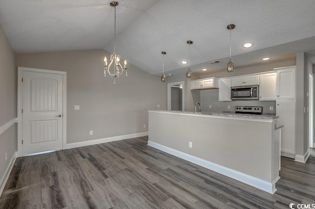 5087 Marigold Rd, Conway, SC 29527 - kitchen with stainless steel microwave, dark wood finished floors, white cabinets, lofted ceiling, and a chandelier