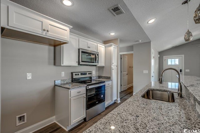 5087 Marigold Rd, Conway, SC 29527 - kitchen with appliances with stainless steel finishes, dark wood-style flooring, white cabinetry, a textured ceiling, and light stone countertops