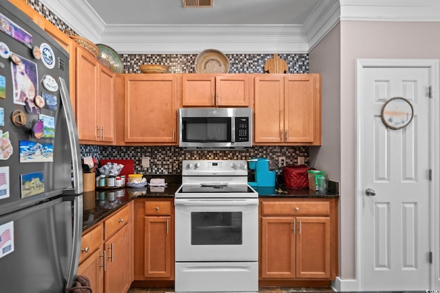 190 Olde Towne Way Unit 3, Myrtle Beach, SC 29588 - kitchen featuring appliances with stainless steel finishes, crown molding, decorative backsplash, and dark stone counters