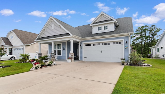 3382 Eversheen Dr, Little River, SC 29566 - craftsman-style house with a porch, driveway, a front yard, and a shingled roof