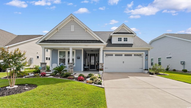 3382 Eversheen Dr, Little River, SC 29566 - craftsman-style house with covered porch, roof with shingles, a front lawn, and driveway