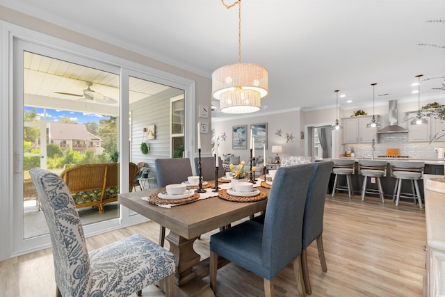 3382 Eversheen Dr, Little River, SC 29566 - dining area with light wood-type flooring, ornamental molding, and a chandelier