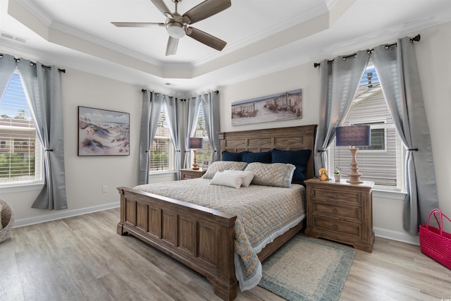 3382 Eversheen Dr, Little River, SC 29566 - bedroom with a tray ceiling, light wood finished floors, crown molding, and a ceiling fan