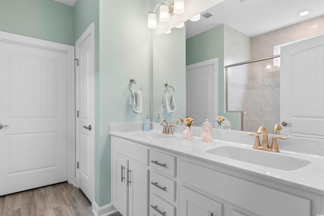3382 Eversheen Dr, Little River, SC 29566 - full bathroom featuring double vanity, tiled shower, and wood finished floors