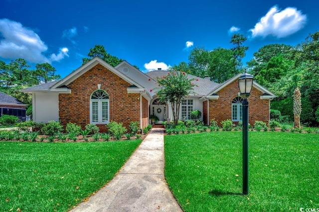 3535 Golf Ave, Little River, SC 29566 - view of front facade featuring a front yard, french doors, and brick siding
