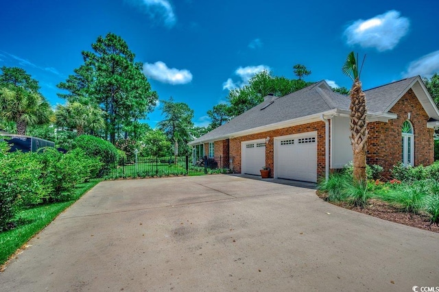 3535 Golf Ave, Little River, SC 29566 - view of side of home with driveway, a garage, brick siding, and roof with shingles