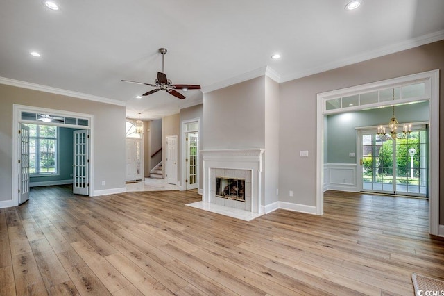3535 Golf Ave, Little River, SC 29566 - unfurnished living room featuring a chandelier, light wood-style flooring, stairway, ornamental molding, and a ceiling fan