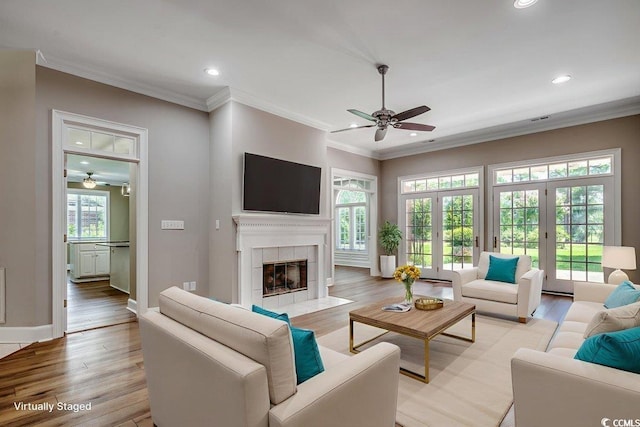 3535 Golf Ave, Little River, SC 29566 - living area featuring a ceiling fan, light wood finished floors, recessed lighting, ornamental molding, and a tiled fireplace