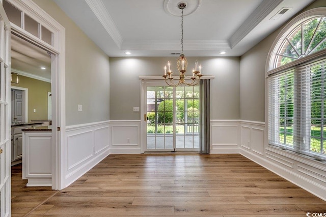 3535 Golf Ave, Little River, SC 29566 - unfurnished dining area featuring a chandelier, plenty of natural light, light wood-type flooring, ornamental molding, and wainscoting