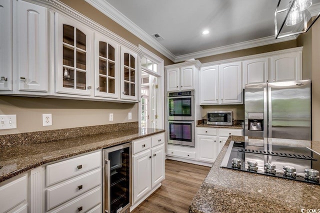 3535 Golf Ave, Little River, SC 29566 - kitchen featuring appliances with stainless steel finishes, wine cooler, white cabinetry, glass insert cabinets, and crown molding