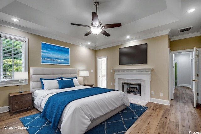 3535 Golf Ave, Little River, SC 29566 - bedroom with crown molding, light wood-style flooring, a fireplace, recessed lighting, and ceiling fan