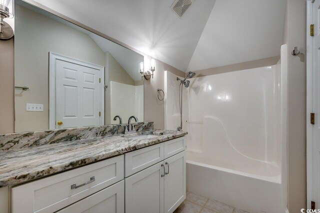3535 Golf Ave, Little River, SC 29566 - bathroom with vanity, bathtub / shower combination, lofted ceiling, and tile patterned flooring
