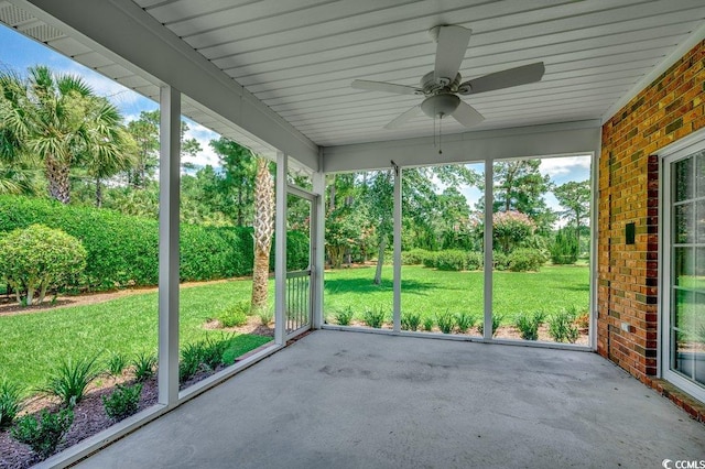 3535 Golf Ave, Little River, SC 29566 - unfurnished sunroom featuring ceiling fan, plenty of natural light, and view of wooded area