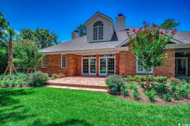 3535 Golf Ave, Little River, SC 29566 - back of property with a chimney, a lawn, a patio area, and brick siding