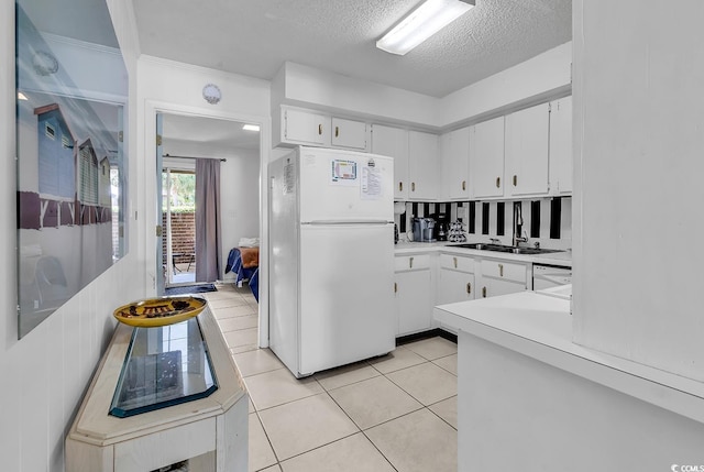 10200 Lake Shore Dr Unit 26, Myrtle Beach, SC 29572 - kitchen with white appliances, light countertops, white cabinets, light tile patterned flooring, and a textured ceiling