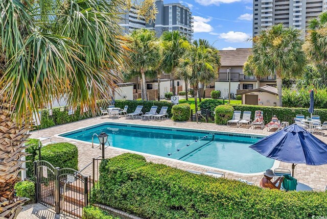 10200 Lake Shore Dr Unit 26, Myrtle Beach, SC 29572 - community pool with a gate and a patio