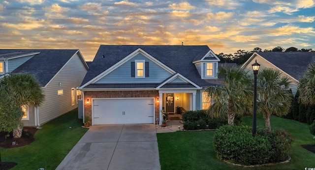 756 Culbertson Ave, Myrtle Beach, SC 29577 - view of front of home with driveway, a standing seam roof, a yard, brick siding, and a metal roof