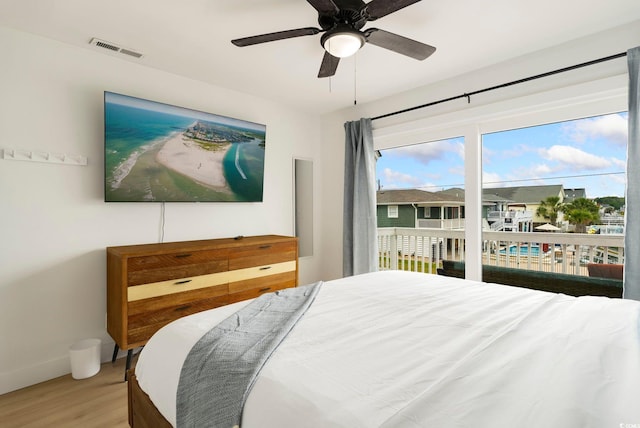 5700 Nixon St, North Myrtle Beach, SC 29582 - bedroom featuring light wood-style flooring, access to exterior, and a ceiling fan
