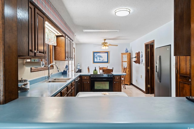 218 Lander Dr, Conway, SC 29526 - kitchen with appliances with stainless steel finishes, ceiling fan, dark brown cabinetry, a textured ceiling, and decorative backsplash