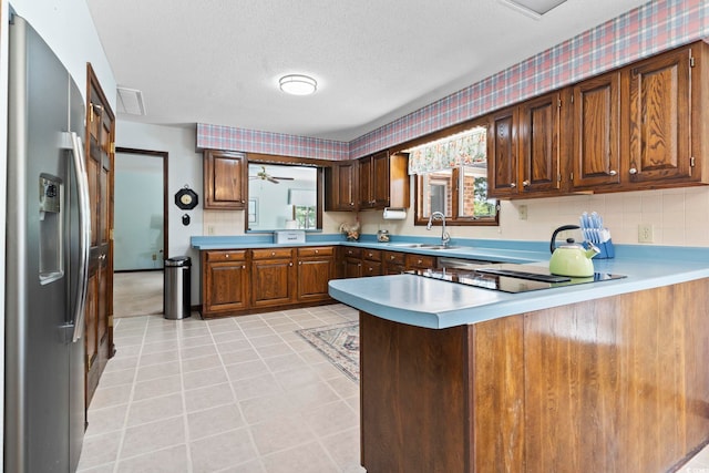 218 Lander Dr, Conway, SC 29526 - kitchen featuring stainless steel fridge, a peninsula, light countertops, a textured ceiling, and black electric cooktop