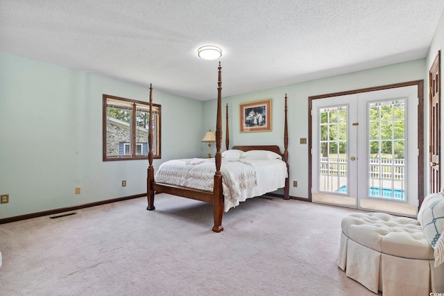 218 Lander Dr, Conway, SC 29526 - bedroom with access to exterior, light carpet, french doors, and a textured ceiling