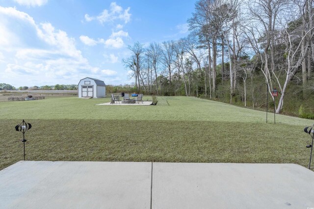 250 Ole Maple St, Loris, SC 29569 - view of green lawn with a storage unit and a patio area