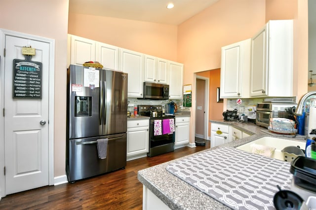 434 Deerfield Links Dr, Surfside Beach, SC 29575 - kitchen with stainless steel appliances, tasteful backsplash, high vaulted ceiling, white cabinetry, and dark wood-style floors