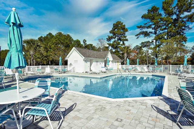 434 Deerfield Links Dr, Surfside Beach, SC 29575 - community pool featuring a patio and view of scattered trees