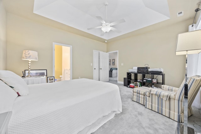371 Sea Turtle Dr, Myrtle Beach, SC 29588 - bedroom with light colored carpet, a raised ceiling, a ceiling fan, and connected bathroom