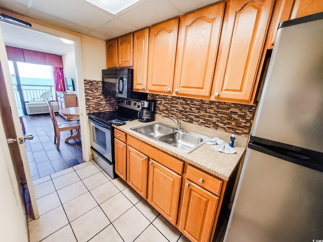 6804 N Ocean Blvd Unit 1621, Myrtle Beach, SC 29572 - kitchen featuring stainless steel appliances, light countertops, light tile patterned floors, and decorative backsplash