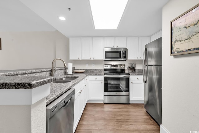 2701 S Ocean Blvd Unit 705, North Myrtle Beach, SC 29582 - kitchen featuring stainless steel appliances, a peninsula, white cabinets, stone counters, and recessed lighting