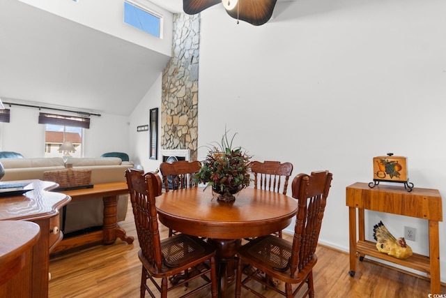 503 Plantation Dr, Surfside Beach, SC 29575 - dining room featuring light wood-style flooring, ceiling fan, and a high ceiling
