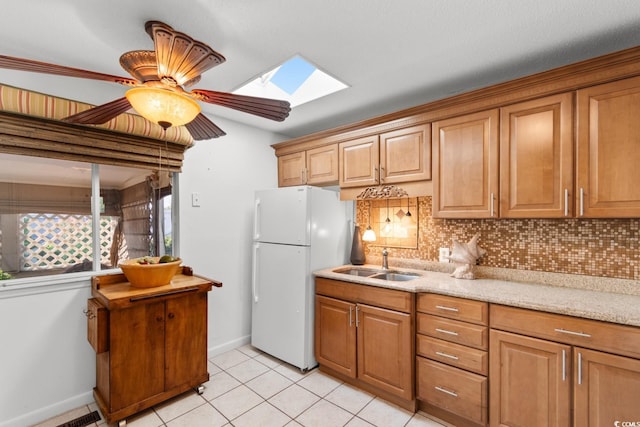 503 Plantation Dr, Surfside Beach, SC 29575 - kitchen featuring a skylight, freestanding refrigerator, backsplash, light tile patterned floors, and a ceiling fan