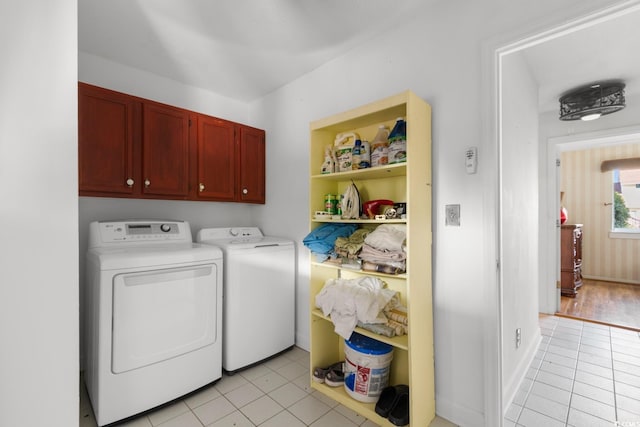 503 Plantation Dr, Surfside Beach, SC 29575 - laundry area featuring washer and dryer, light tile patterned floors, and cabinet space