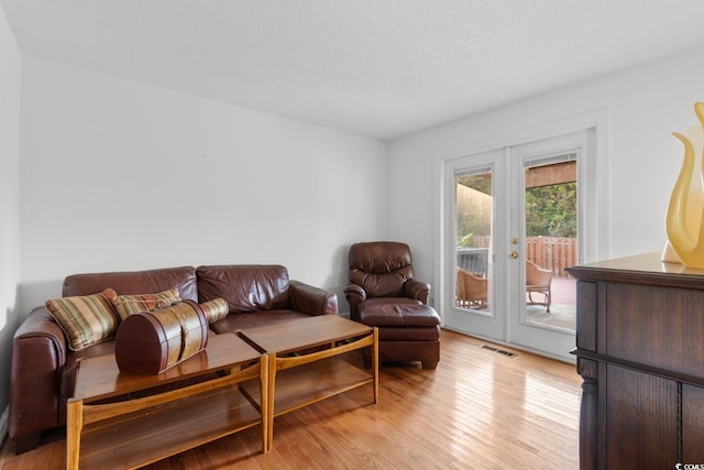 503 Plantation Dr, Surfside Beach, SC 29575 - living room with french doors and light wood-type flooring