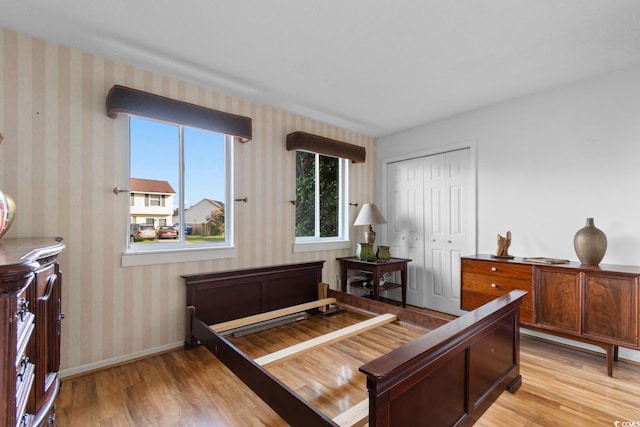 503 Plantation Dr, Surfside Beach, SC 29575 - bedroom featuring light wood-style floors, a closet, and wallpapered walls