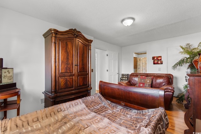 503 Plantation Dr, Surfside Beach, SC 29575 - bedroom with wood finished floors and a textured ceiling