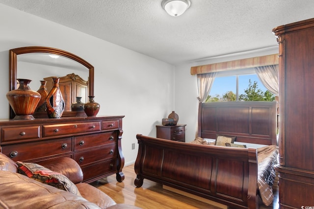 503 Plantation Dr, Surfside Beach, SC 29575 - bedroom with light wood-type flooring and a textured ceiling