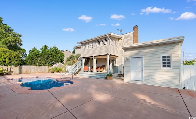503 Plantation Dr, Surfside Beach, SC 29575 - back of property with a patio area, a fenced backyard, a chimney, and stairs